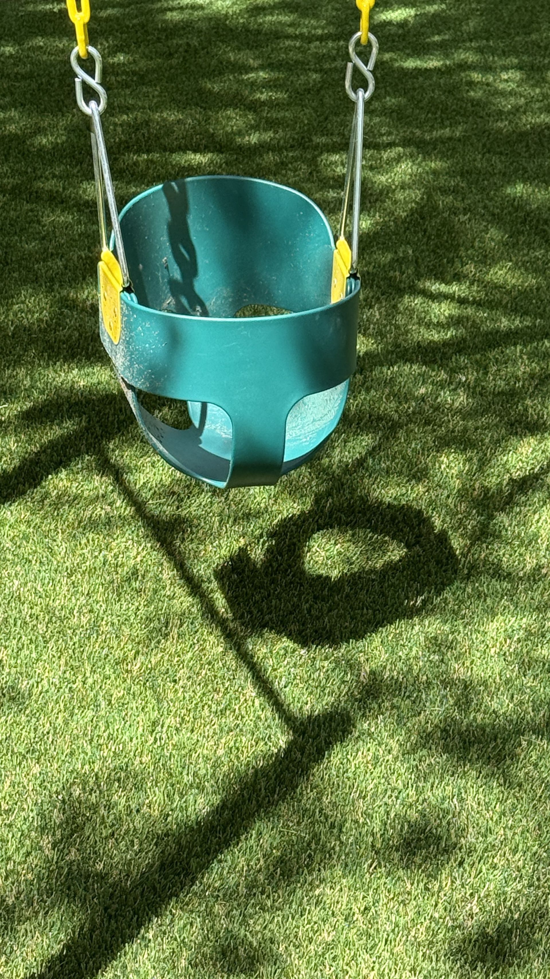 Baby swing on artificial turf safe play surface