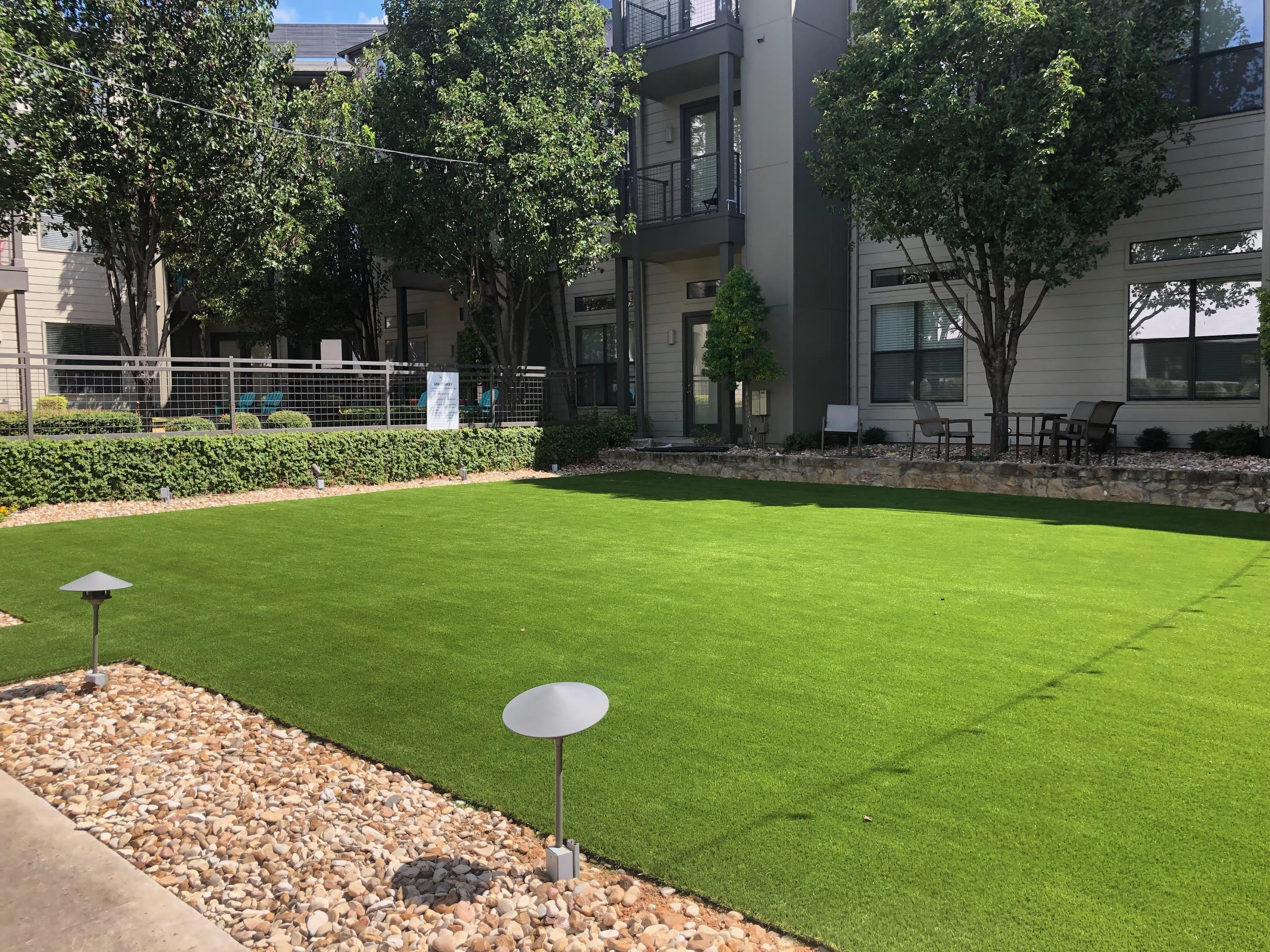 Commercial apartment courtyard with pathlights - Green Forever Turf Texas