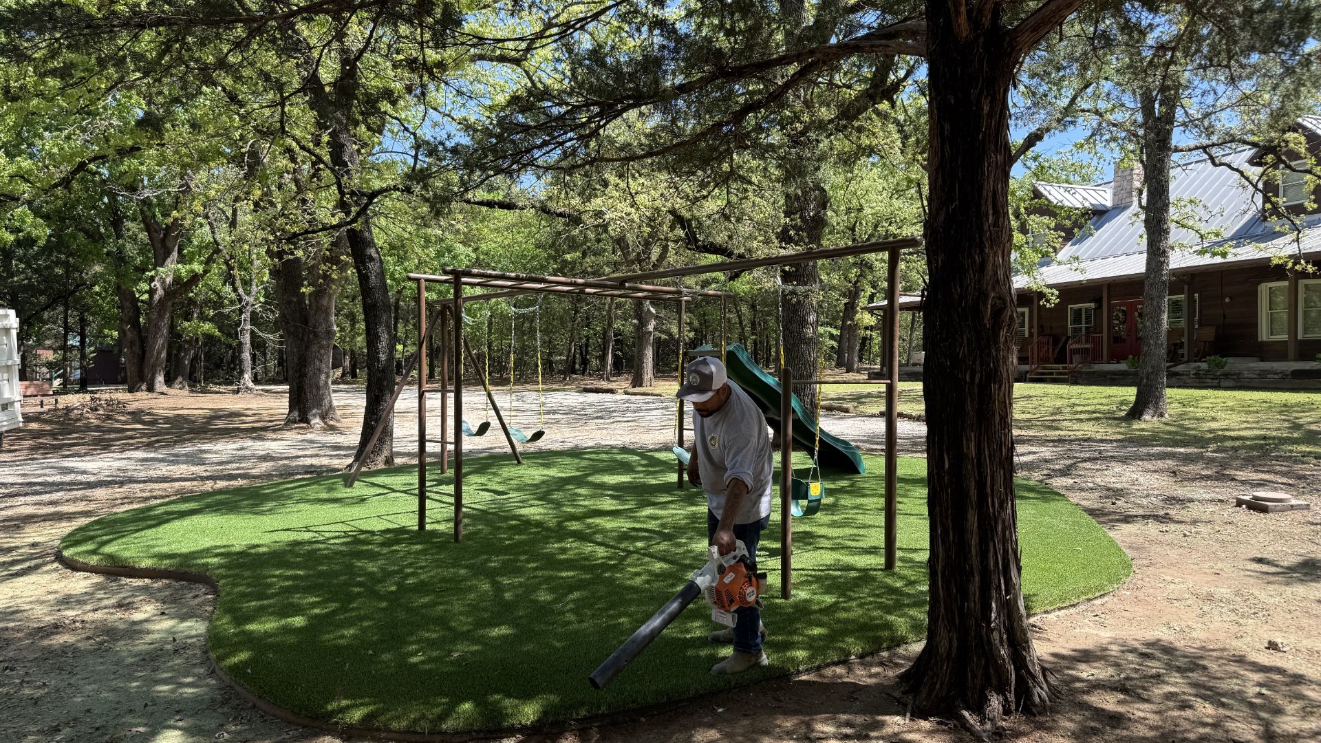 Green Forever Turf crew finishing playground turf installation in DFW