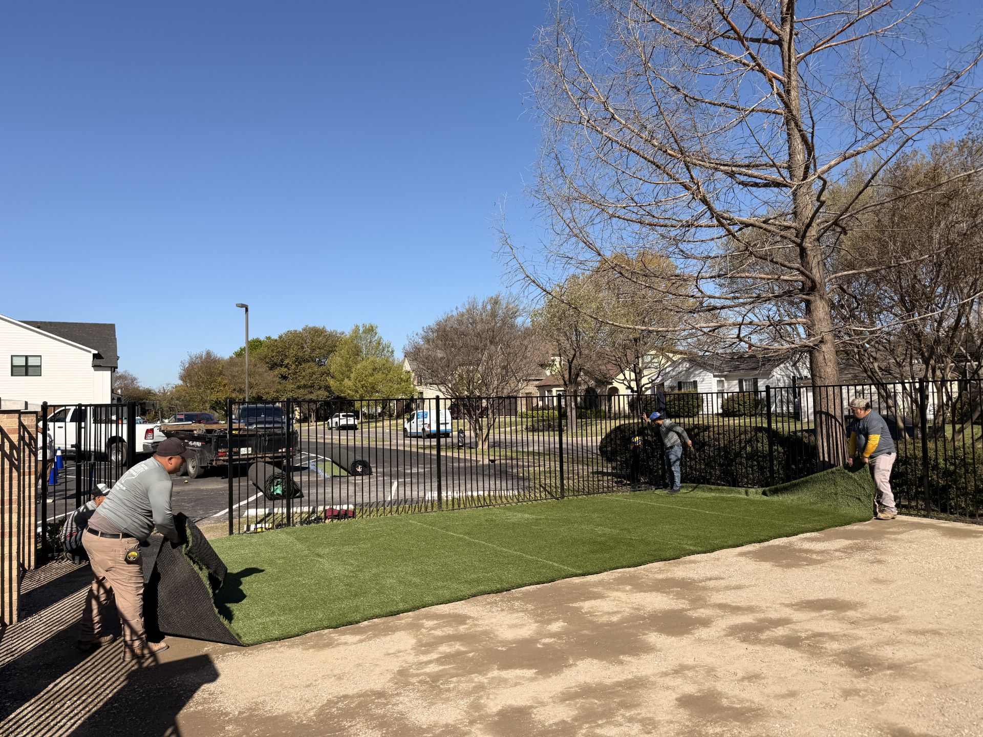 Crew laying synthetic turf field in Dallas
