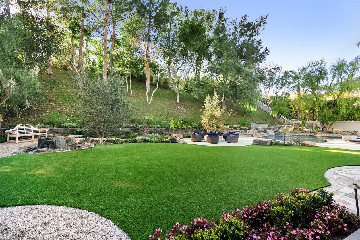 Luxury backyard with synthetic turf and water feature