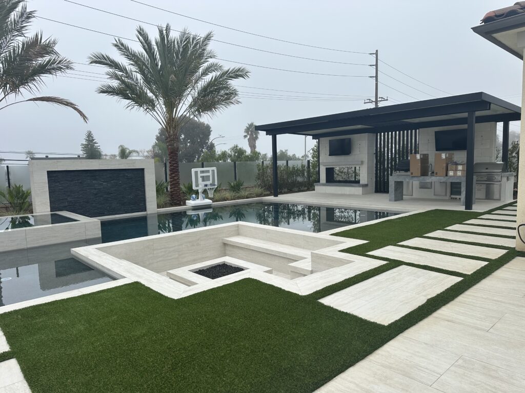 Poolside pavers and turf with integrated drainage