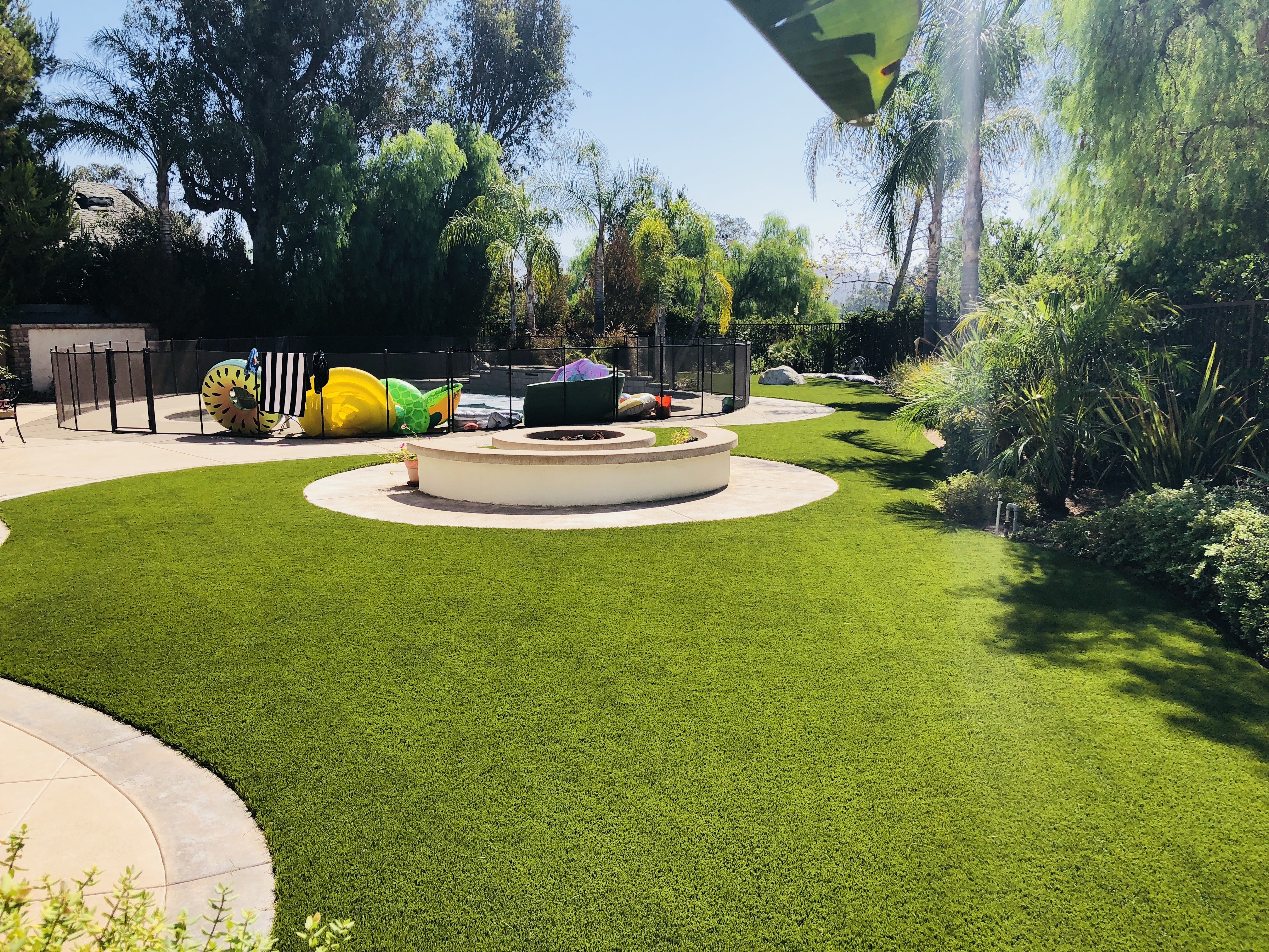 Residential backyard firepit and playset - Green Forever Turf Texas