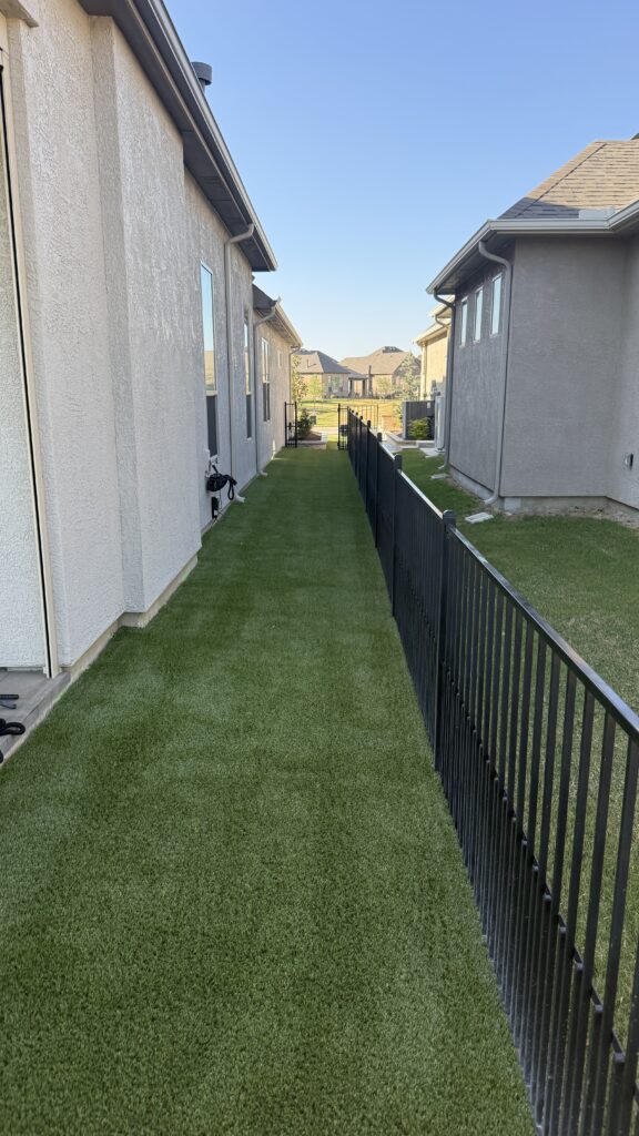 Side yard artificial turf installation between houses DFW